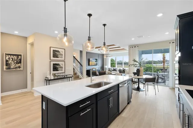 a kitchen with a sink a stove a refrigerator and island