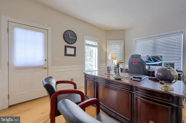 a kitchen with stainless steel appliances granite countertop a sink and a granite counter tops with white cabinets