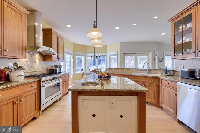 a dining room with furniture a chandelier and wooden floor