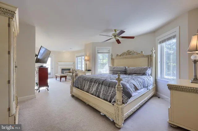 a view of an empty room with closet and a window