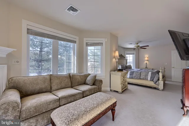 a bathroom with a granite countertop sink a toilet and a mirror