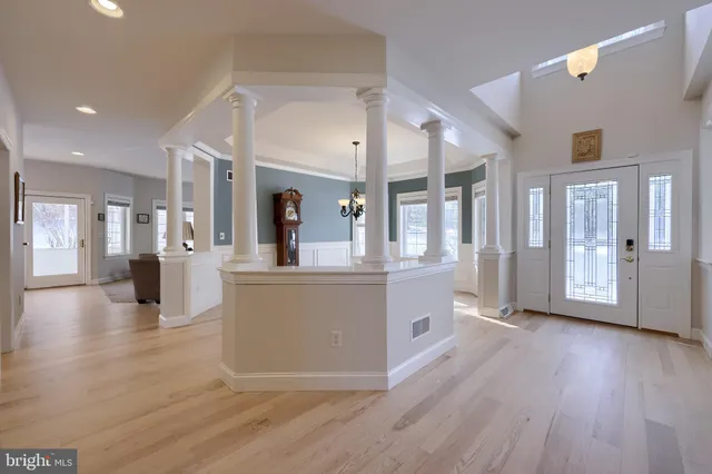 a view of a big room with wooden floor and windows