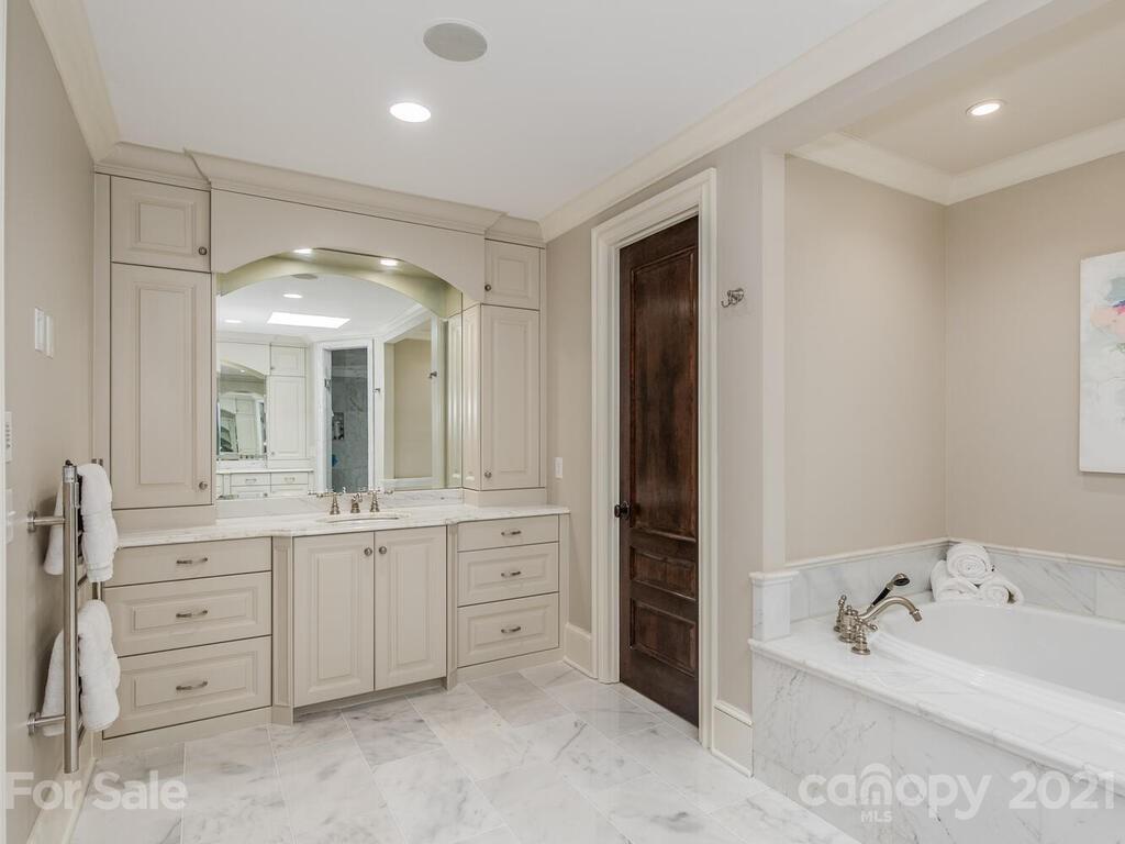 3422 Sharon Road Charlotte, NC 28211 - Photo 23 of 48 a spacious bathroom with a double vanity sink mirror and bathtub