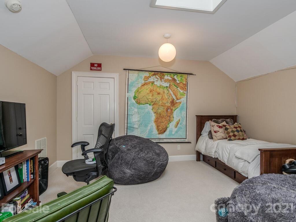 3422 Sharon Road Charlotte, NC 28211 - Photo 36 of 48 a bedroom with two beds and a large mirror next to a window