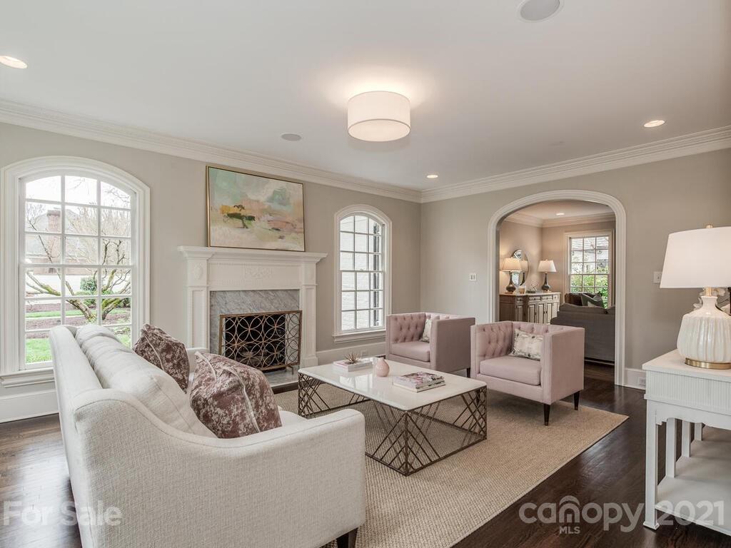 3422 Sharon Road Charlotte, NC 28211 - Photo 7 of 48 a living room with furniture a fireplace and a large window