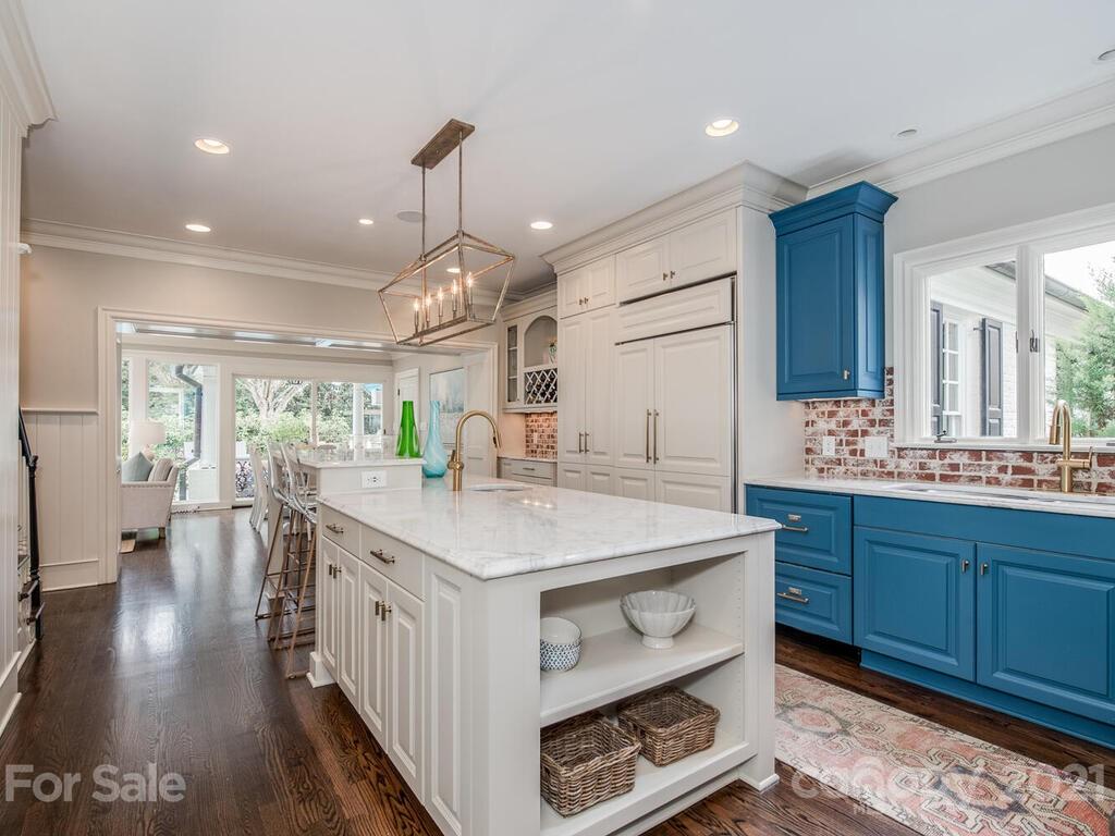3422 Sharon Road Charlotte, NC 28211 - Photo 10 of 48 a kitchen with center island and wooden floor