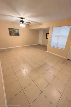 a living room with a couch and a potted plant