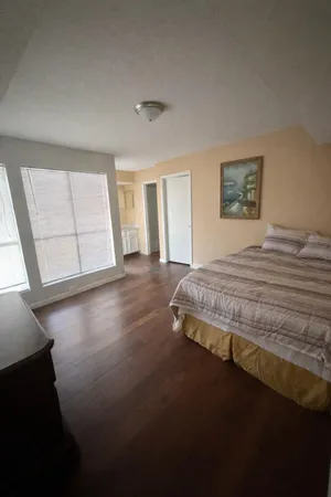 a bedroom with a bed and window