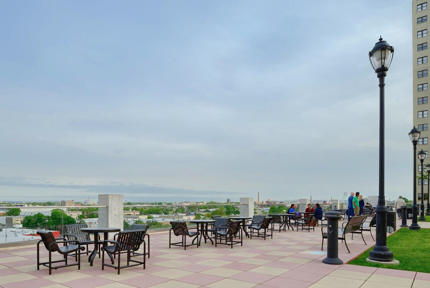 4 Beacon Way, Unit 211 Jersey City, NJ 07304 - Photo 12 of 22 a view of a tables and chairs in patio
