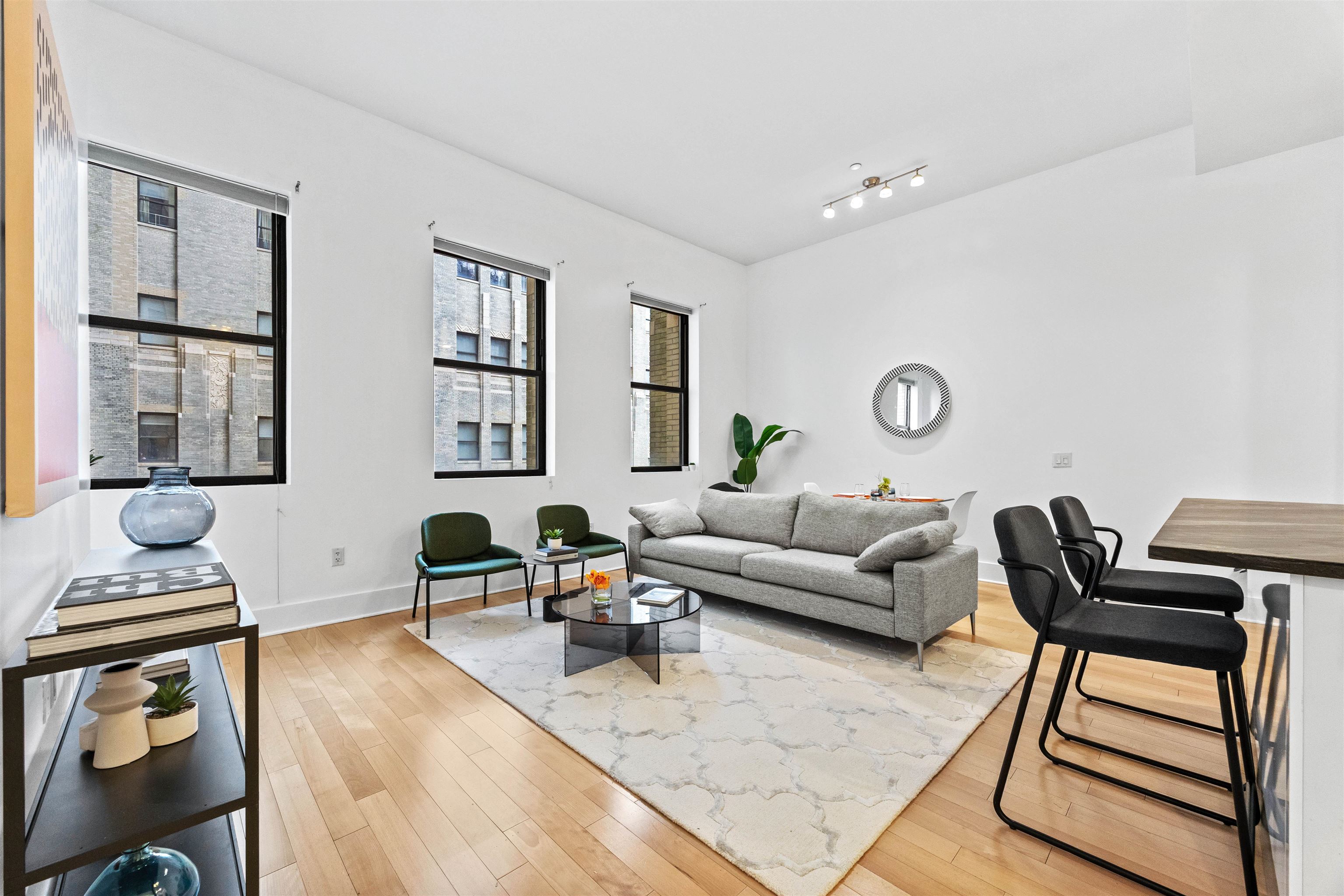 4 Beacon Way, Unit 211 Jersey City, NJ 07304 - Photo 5 of 22 a living room with furniture and wooden floor
