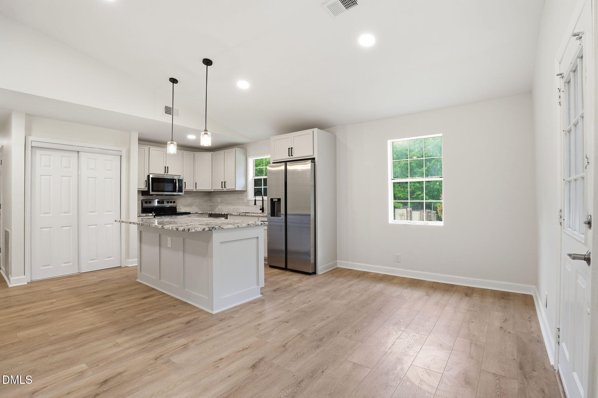 3602 Harrison Road Castalia, NC 27816 - Photo 29 of 48 a kitchen with kitchen island white cabinets and refrigerator