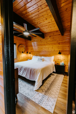 1413 Basel Drive Midway, UT 84049 - Photo 83 of 137 Bedroom with wooden walls, a wooden ceiling with exposed beams, light wood finished floors, and ceiling fan
