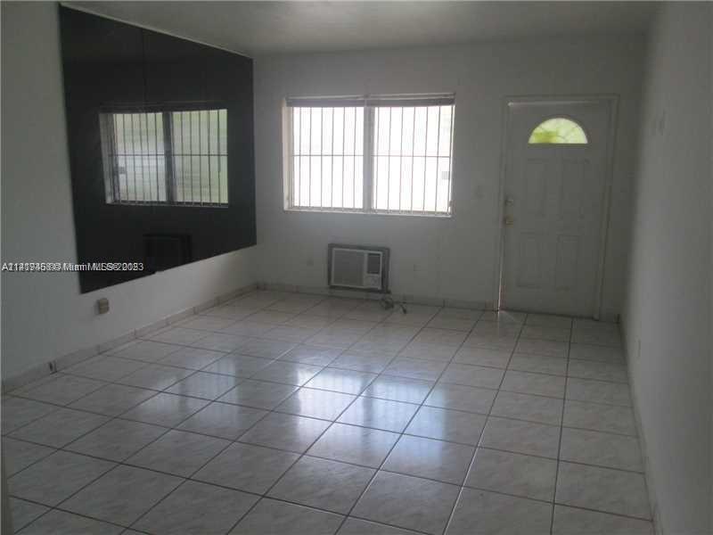 7720 Harding Avenue, Unit 11 Miami Beach, FL 33141 - Photo 6 of 7 a view of an empty room with a window