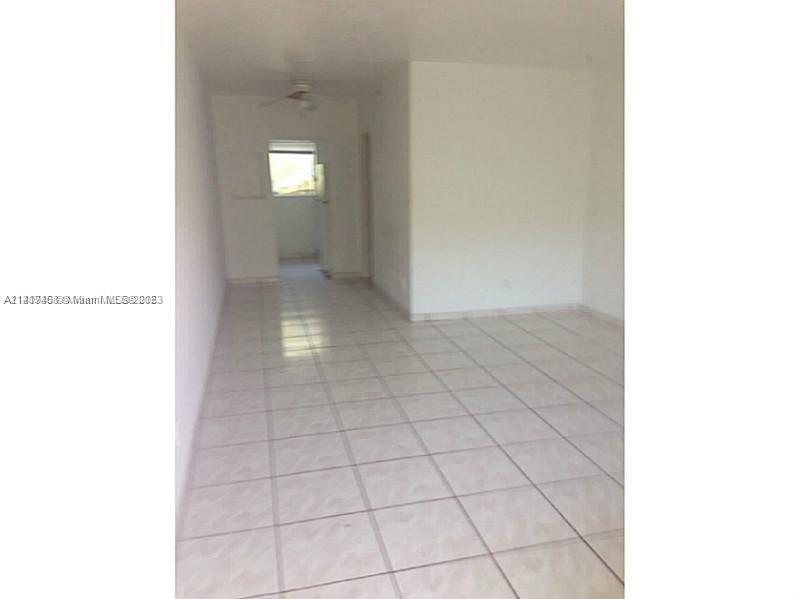 7720 Harding Avenue, Unit 11 Miami Beach, FL 33141 - Photo 7 of 7 a view of an empty room with a window