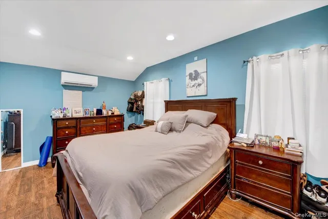 a living room with furniture and a view of kitchen