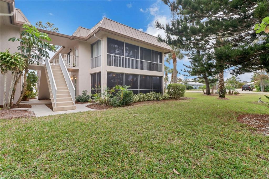 1549 Sandpiper Street, Unit 1 Naples, FL 34102 - Photo 10 of 16 a view of a house with backyard and garden