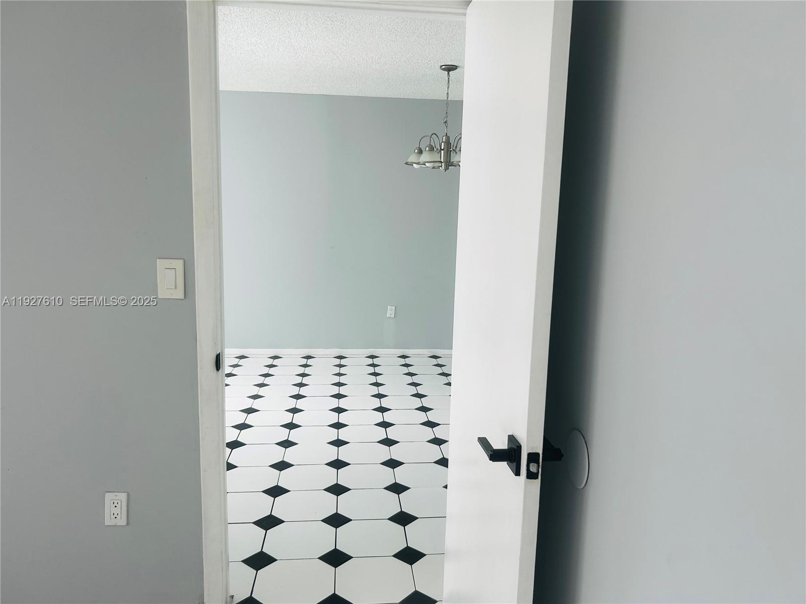 1665 Bay Road, Unit 415 Miami Beach, FL 33139 - Photo 6 of 7 a bathroom with a black white checkered floor