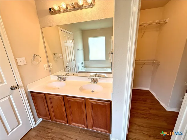 a bathroom with a sink a mirror and vanity