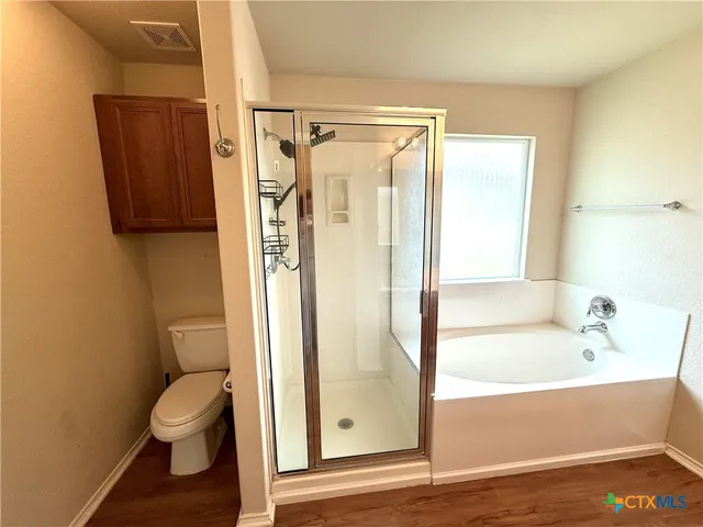 a bathroom with a shower a toilet and a sink