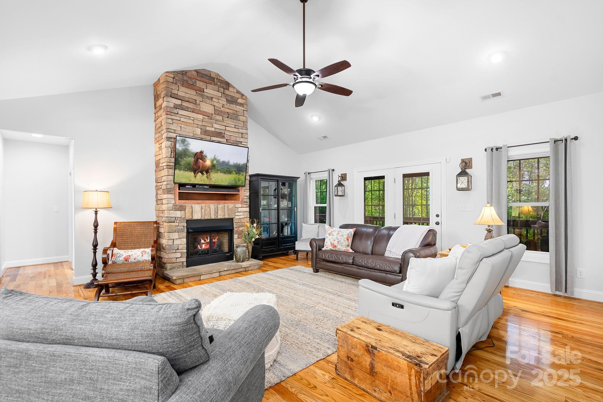 730 Oak Ridge Farms Circle, Unit 14 Newton, NC 28658 - Photo 18 of 42 a living room with furniture a fireplace and a floor to ceiling window