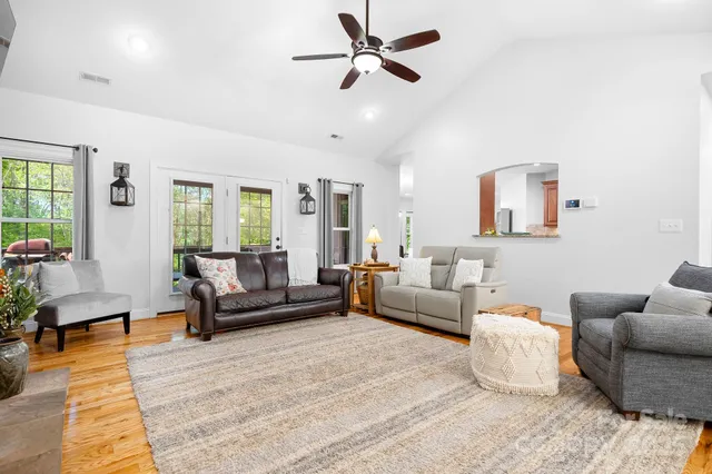 a living room with furniture and a view of bedroom