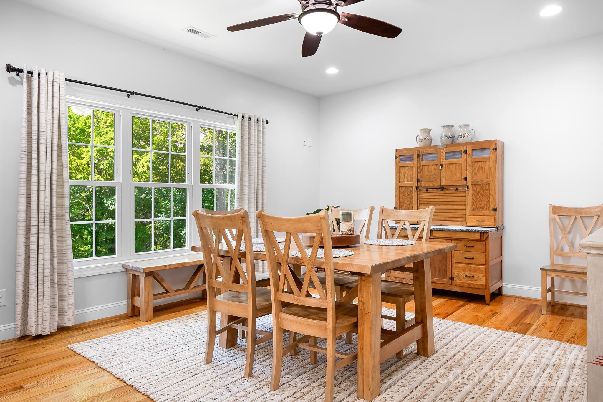 730 Oak Ridge Farms Circle, Unit 14 Newton, NC 28658 - Photo 22 of 42 a view of a dining room with furniture window and wooden floor