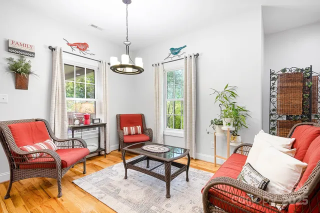 a living room with furniture a rug and a window