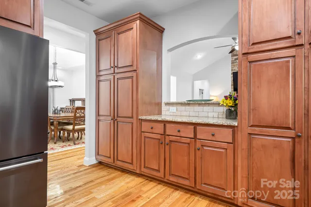 a kitchen with stainless steel appliances granite countertop a refrigerator and a sink