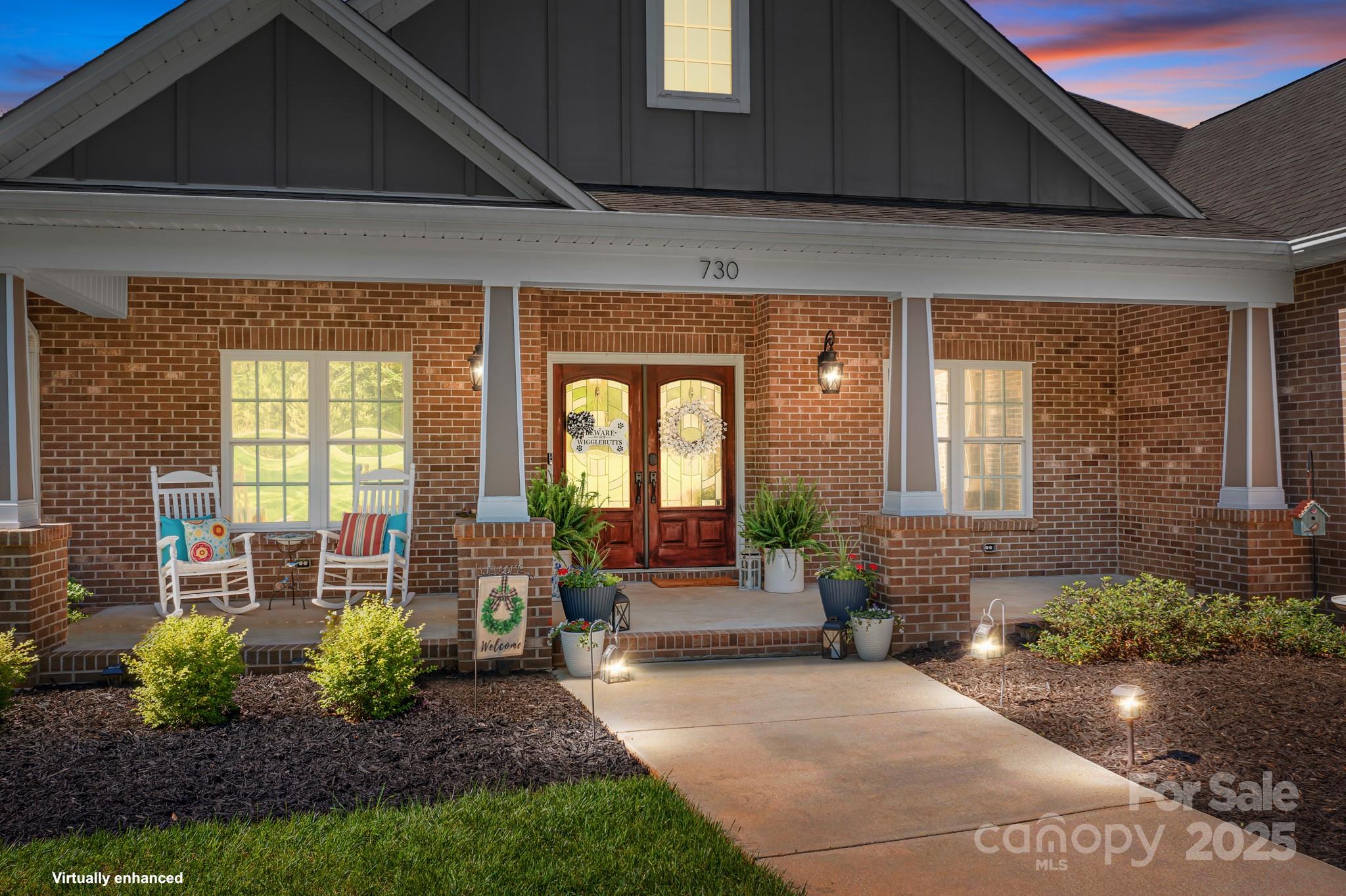 730 Oak Ridge Farms Circle, Unit 14 Newton, NC 28658 - Photo 3 of 42 a front view of a house with outdoor seating and a potted plant
