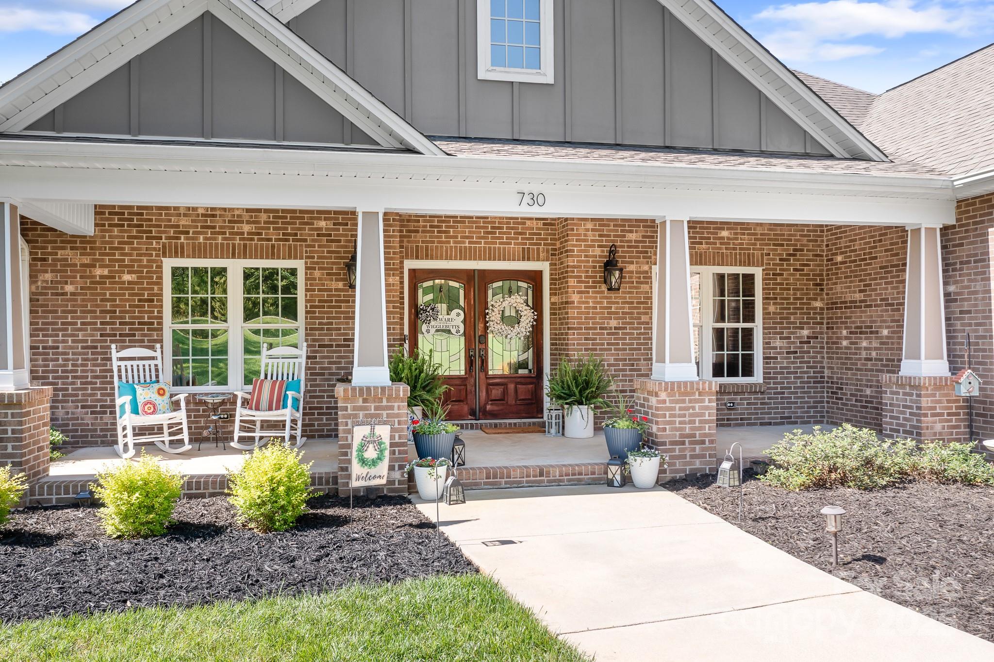 730 Oak Ridge Farms Circle, Unit 14 Newton, NC 28658 - Photo 4 of 42 a front view of a house with garden and plants