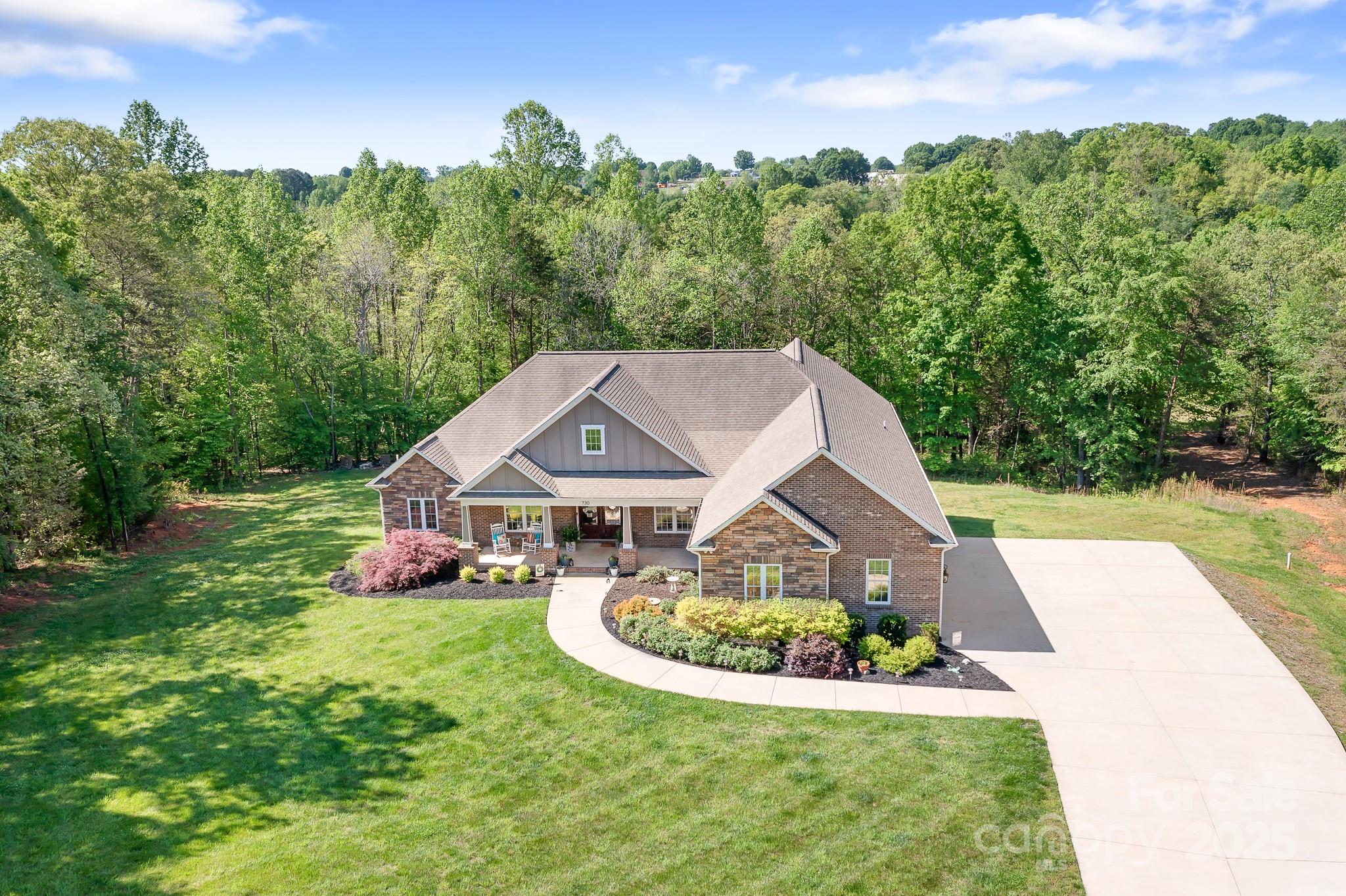 730 Oak Ridge Farms Circle, Unit 14 Newton, NC 28658 - Photo 6 of 42 a aerial view of a house with a yard table and plants