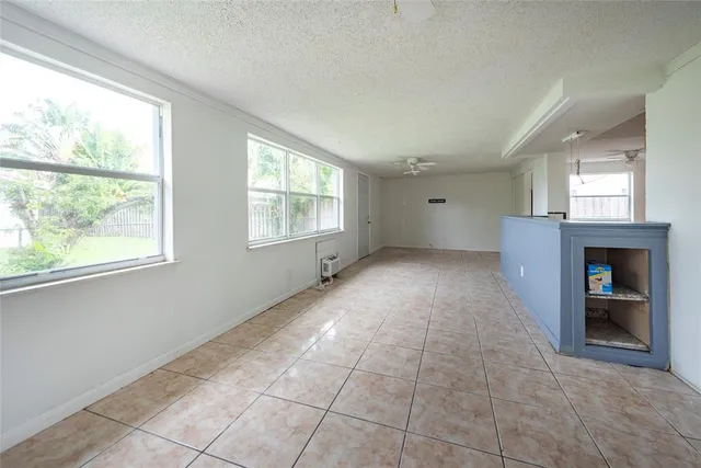 a big room with windows and a fireplace