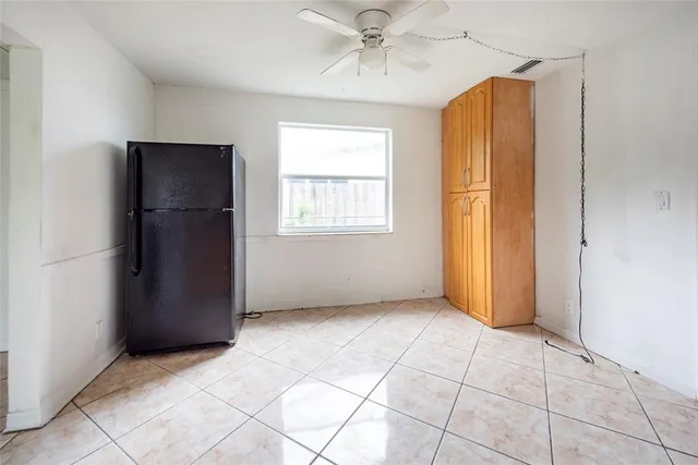 an empty room with windows and closet area