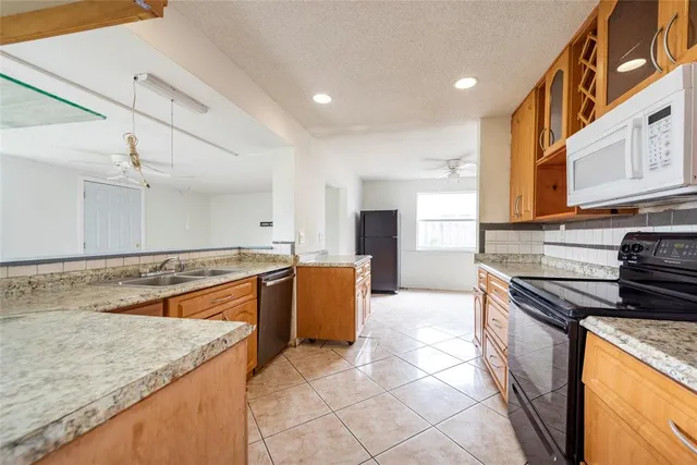 a kitchen with stainless steel appliances granite countertop a stove and a sink