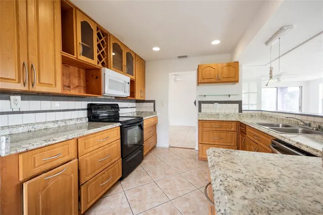 a kitchen with stainless steel appliances granite countertop a stove and a sink