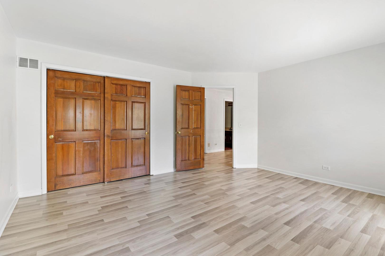 149 West Schick Road Bloomingdale, IL 60108 - Photo 17 of 35 a view of empty room with wooden floor and entryway