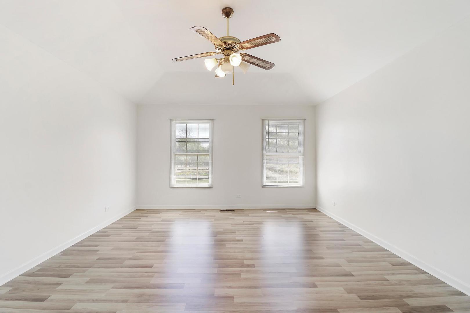 149 West Schick Road Bloomingdale, IL 60108 - Photo 18 of 35 a view of an empty room with wooden floor and a window