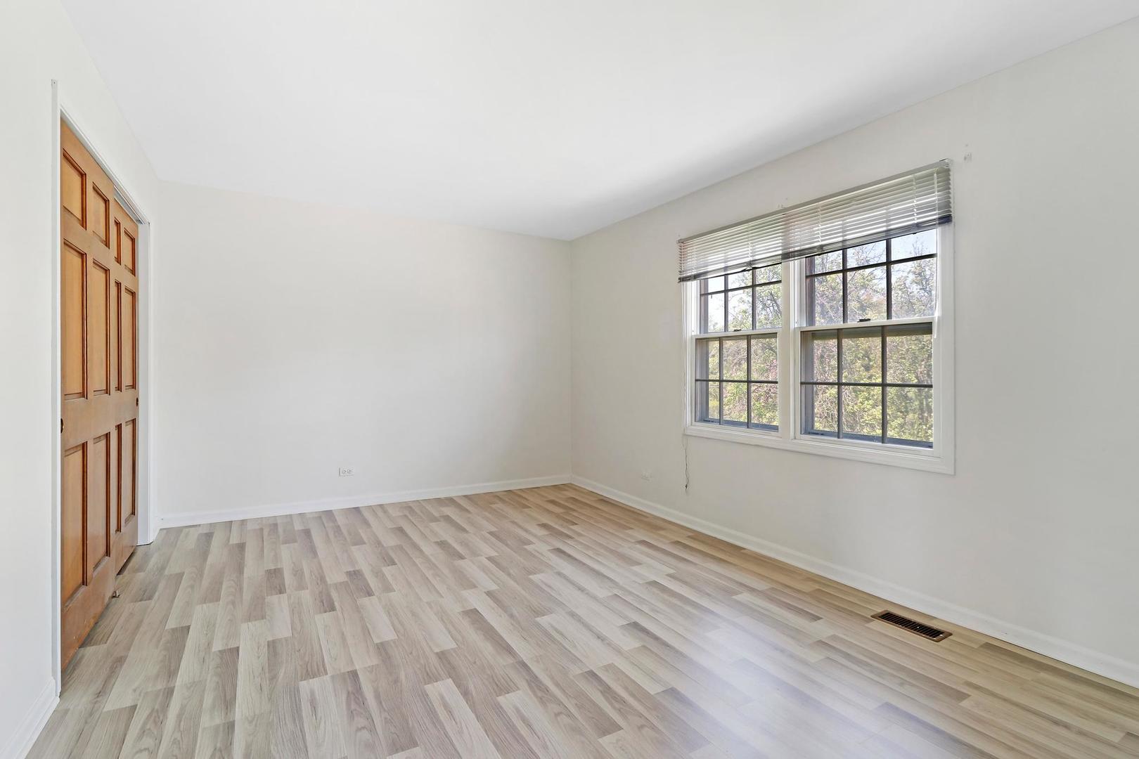 149 West Schick Road Bloomingdale, IL 60108 - Photo 19 of 35 an empty room with wooden floor and windows