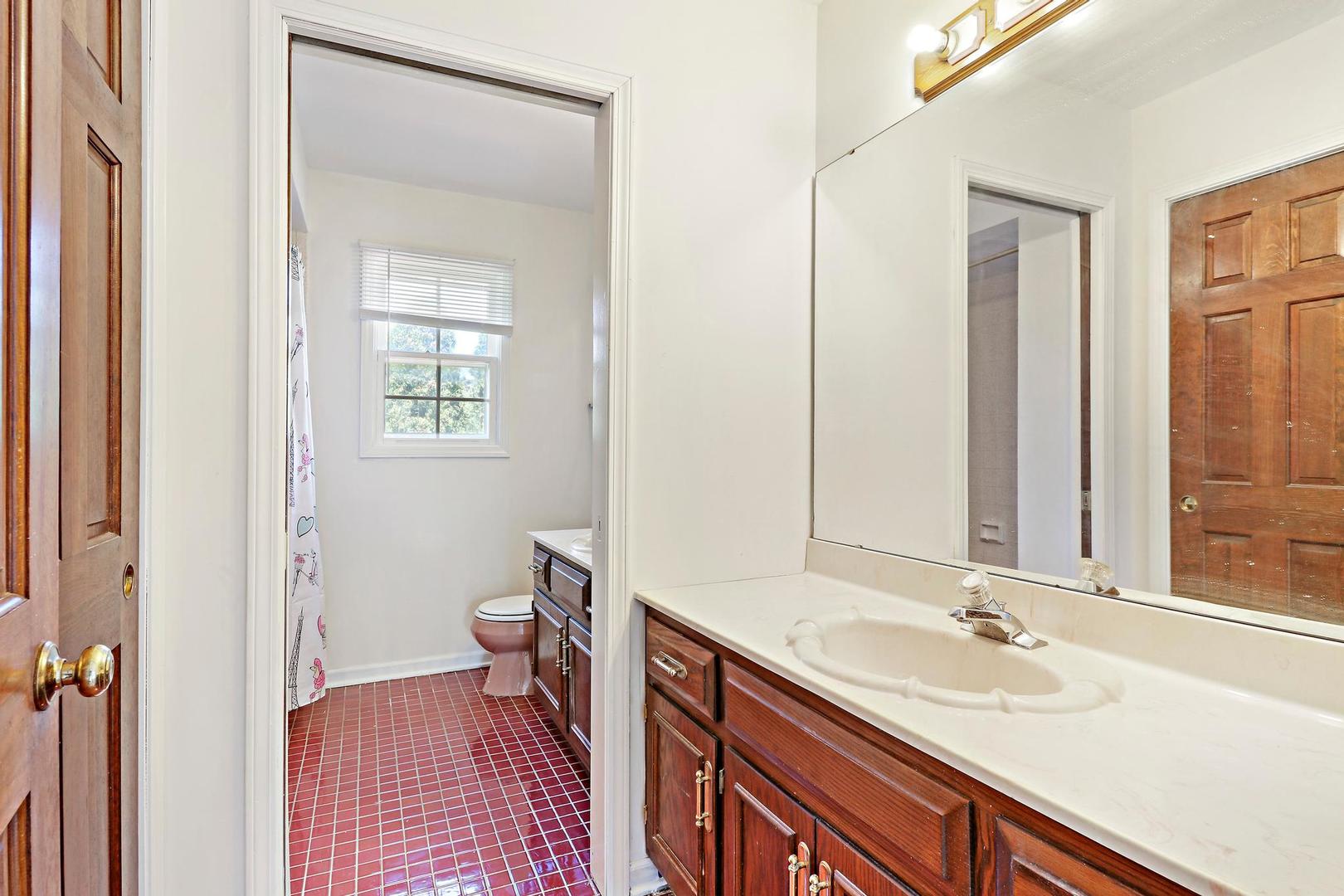 149 West Schick Road Bloomingdale, IL 60108 - Photo 20 of 35 a bathroom with a sink and a mirror
