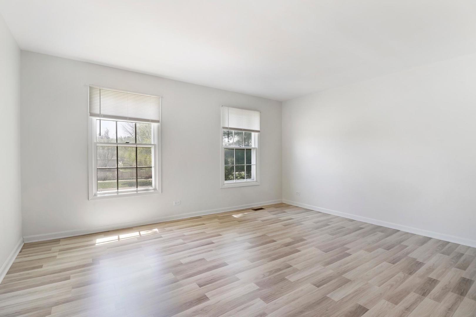 149 West Schick Road Bloomingdale, IL 60108 - Photo 21 of 35 a view of an empty room with wooden floor and a window