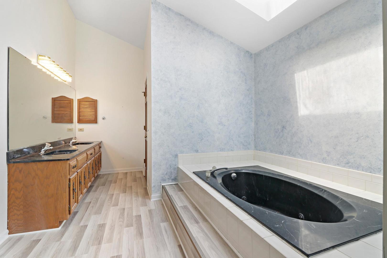 149 West Schick Road Bloomingdale, IL 60108 - Photo 23 of 35 a kitchen with a stove and a sink