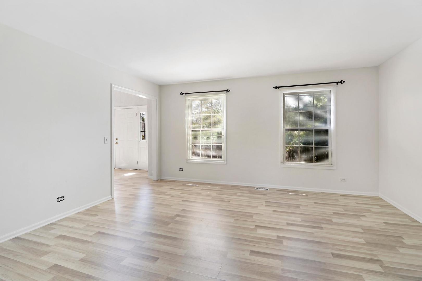 149 West Schick Road Bloomingdale, IL 60108 - Photo 4 of 35 a view of an empty room with wooden floor and a window