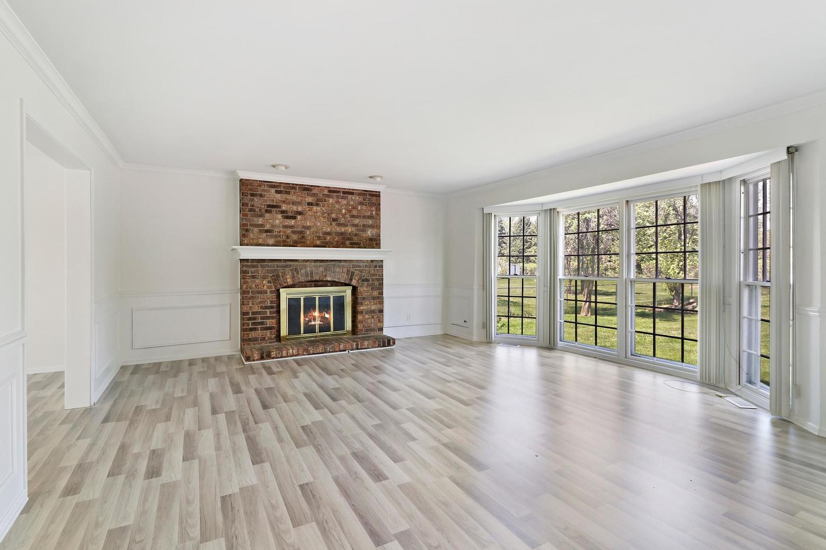 149 West Schick Road Bloomingdale, IL 60108 - Photo 5 of 35 a view of an empty room with wooden floor and a window