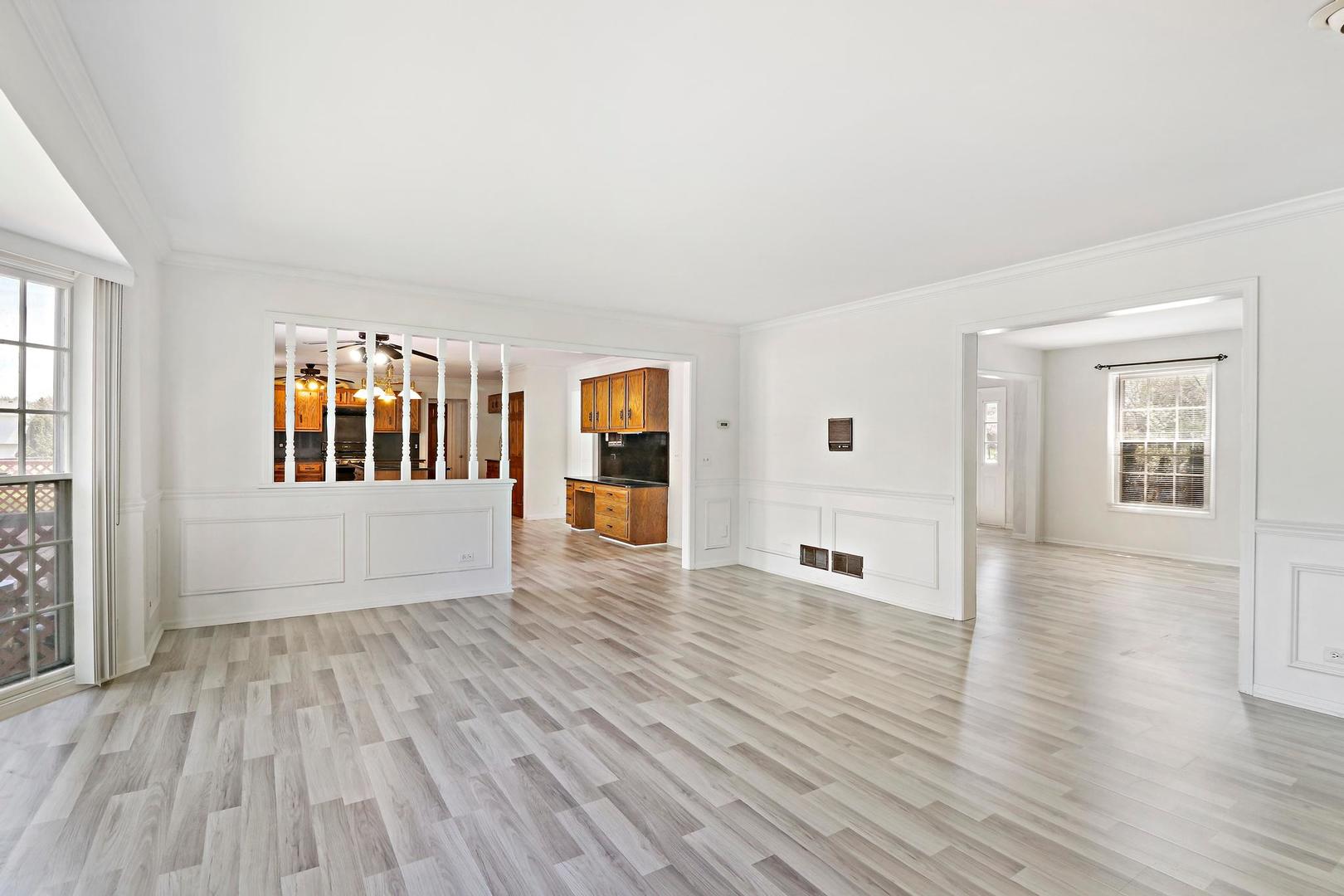 149 West Schick Road Bloomingdale, IL 60108 - Photo 7 of 35 a view of a big room with wooden floor and windows