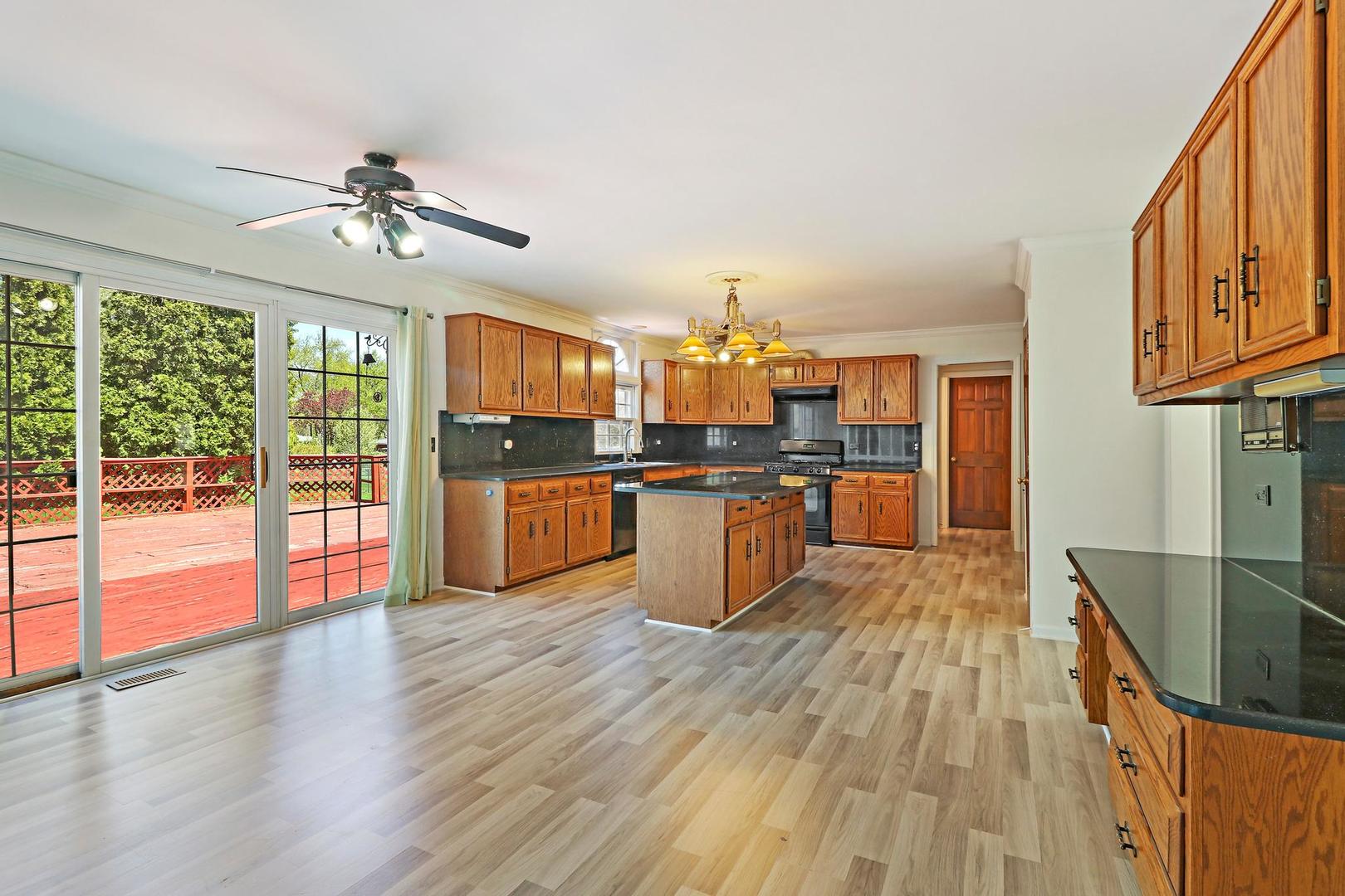 149 West Schick Road Bloomingdale, IL 60108 - Photo 8 of 35 a large kitchen with cabinets wooden floor and stainless steel appliances