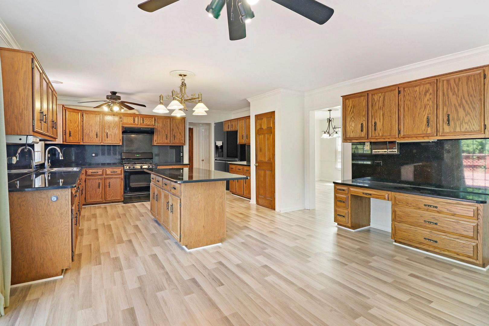 149 West Schick Road Bloomingdale, IL 60108 - Photo 10 of 35 a large kitchen with cabinets wooden floor and stainless steel appliances