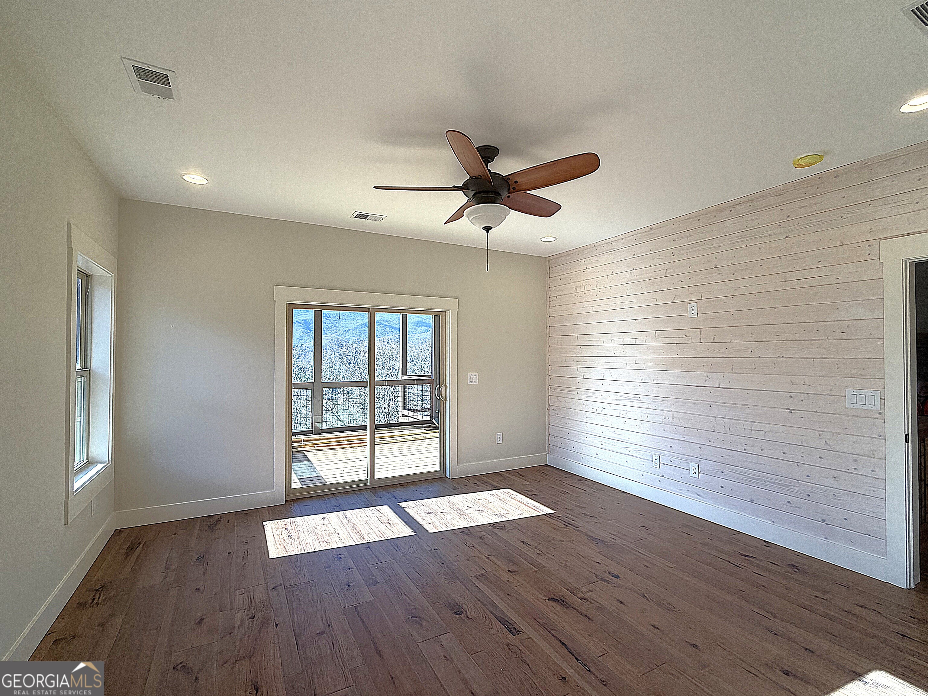 438 Mill Ridge Road Hiawassee, GA 30546 - Photo 11 of 75 an empty room with wooden floor and windows