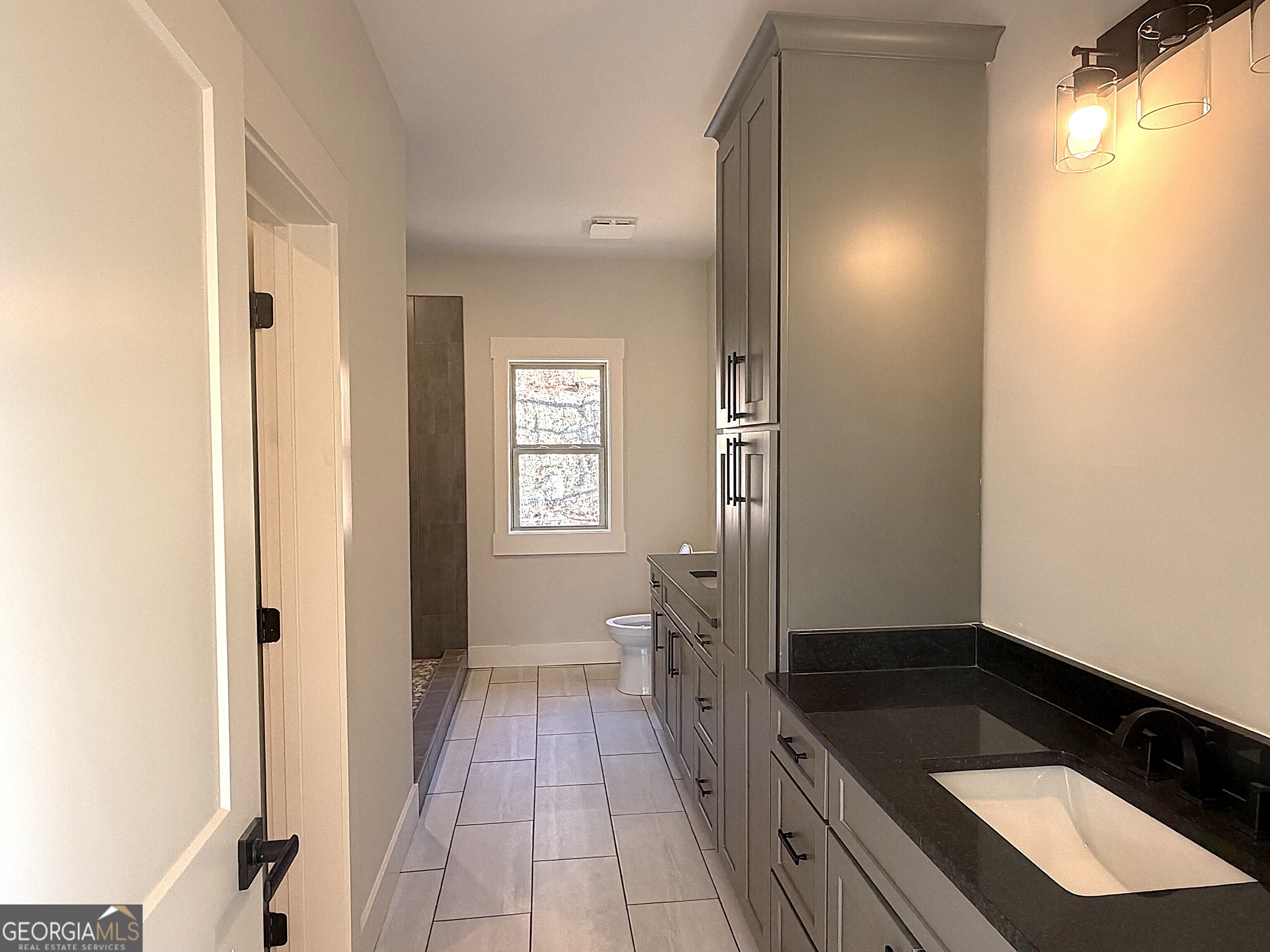 438 Mill Ridge Road Hiawassee, GA 30546 - Photo 13 of 75 a spacious bathroom with a sink a mirror and a shower
