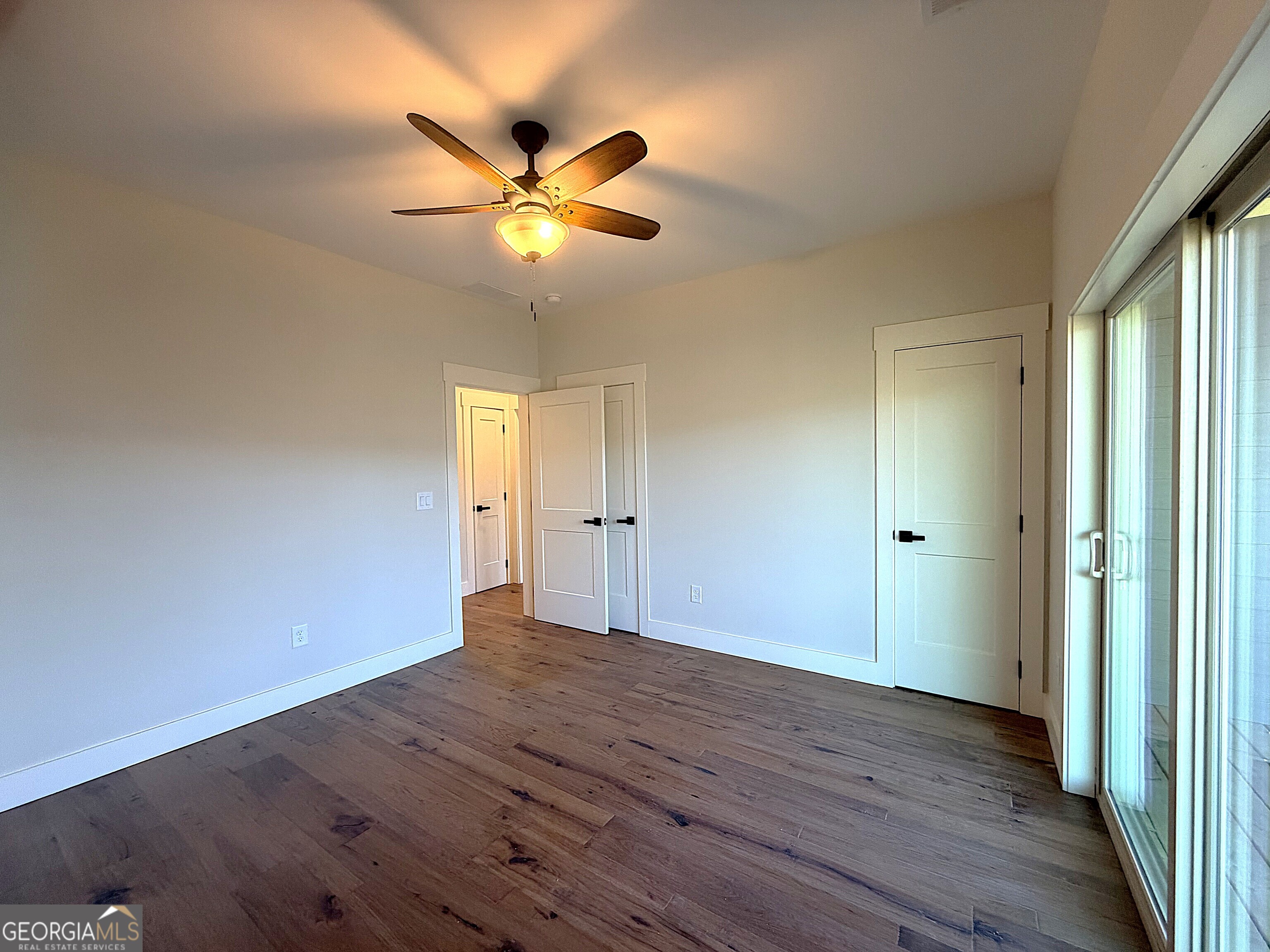 438 Mill Ridge Road Hiawassee, GA 30546 - Photo 17 of 75 a view of an empty room with wooden floor and window