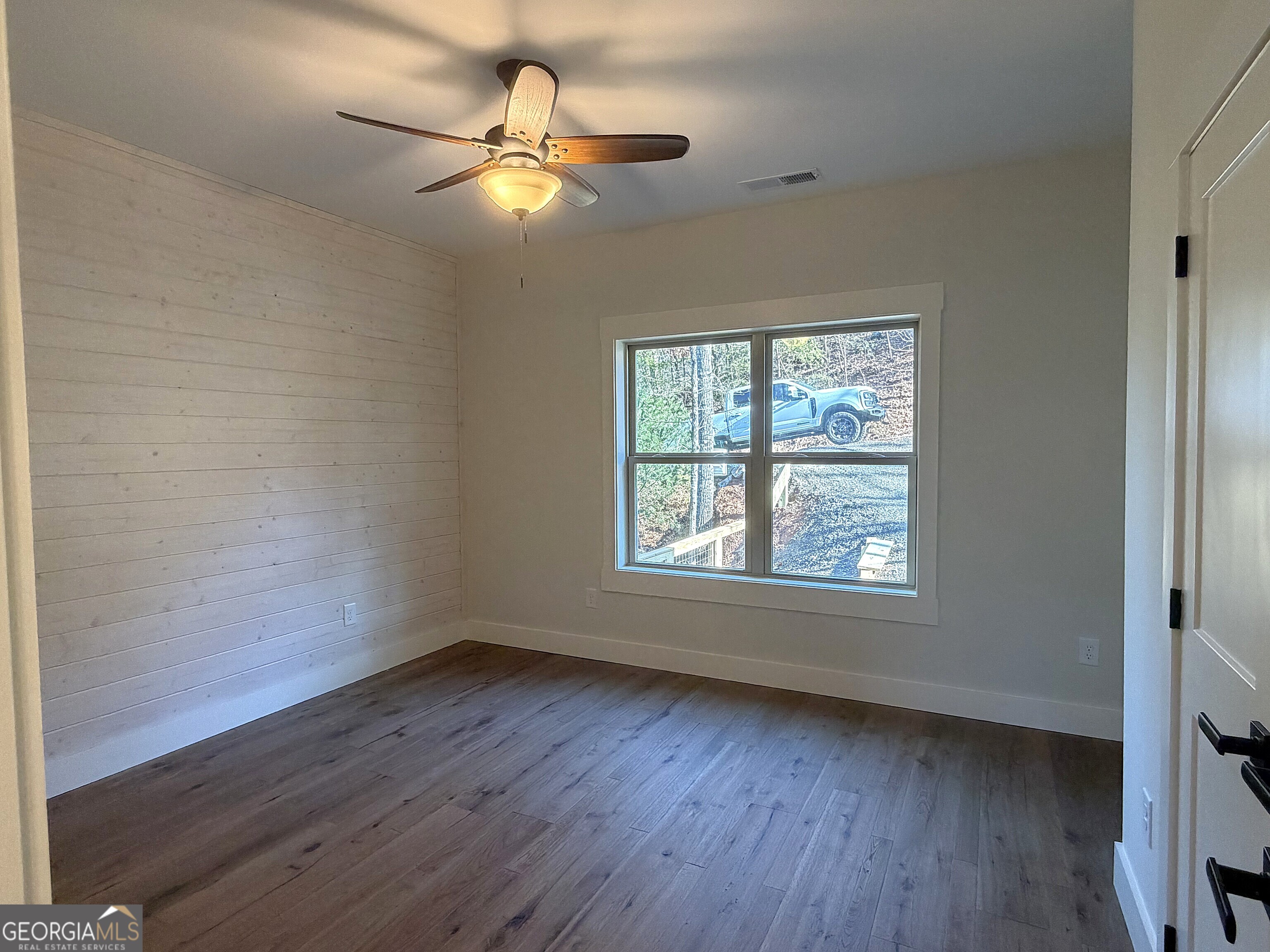 438 Mill Ridge Road Hiawassee, GA 30546 - Photo 19 of 75 a view of an empty room with wooden floor and a window